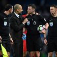 Manchester City's manager Pep Guardiola (2ndL) speaks with referee Michael Oliver after an English Premier League football match against Liverpool on March 19, 2017