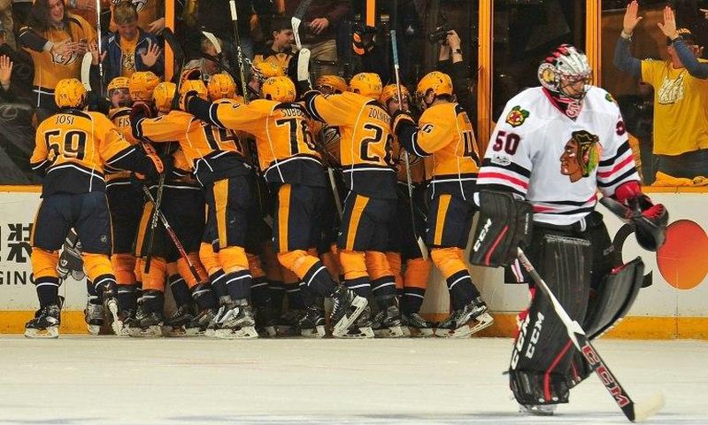 Kevin Fiala is swarmed by Nashville Predators teammates after scoring the game-winning overtime goal against the Chicago Blackhawks