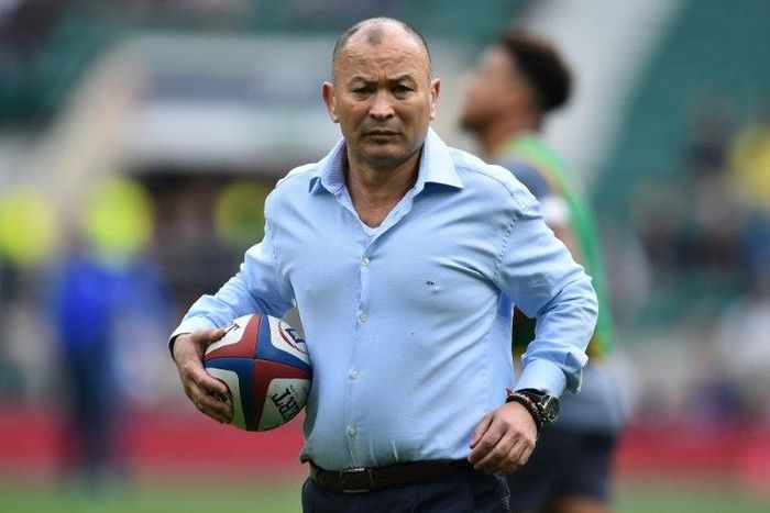 England's head coach Eddie Jones carries a rugby ball ahead of their Six Nations match against Scotland at Twickenham stadium in south west London on March 11, 2017