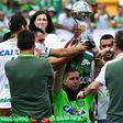 Brazilian Chapecoense goalkeeper Jackson Follmann (C), holds up the Copa Sudamericana trophy before a friendly match against Palmeiras