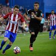 Atletico Madrid's forward Kevin Gameiro (L) vies with Granada's Belgian midfielder Andreas Pereira during the Spanish league football match October 15, 2016