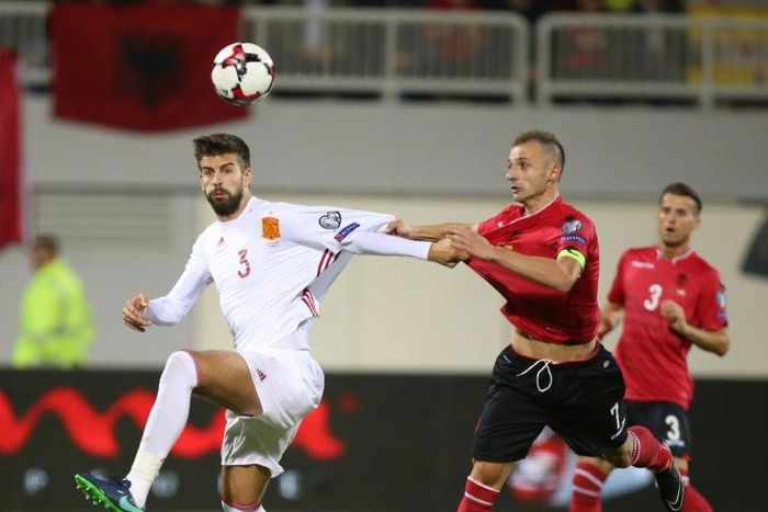 Albania's Ansi Agolli (R) clashes with Spain's Gerard Pique in Shkoder, on October 9, 2016