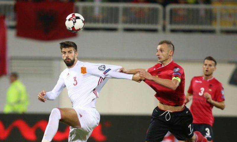 Albania's Ansi Agolli (R) clashes with Spain's Gerard Pique in Shkoder, on October 9, 2016