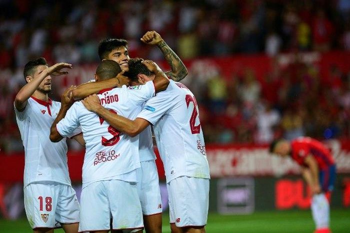 Sevilla's Franco Vazquez (C) celebrates with teammates after scoring a goal during the Spanish league football match against CA Osasuna on May 20, 2017
