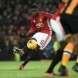 Manchester United's midfielder Paul Pogba strikes the ball as he takes a free-kick during the EFL Cup semi-final football match against Hull City January 10, 2017