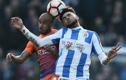 Huddersfield Town's Philip Billing (R) vies with Manchester City's Fabian Delph during their English FA Cup fifth round match on February 18, 2017