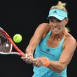 Germany's Angelique Kerber hits a return against Ukraine's Lesia Tsurenko during their women's singles match at the Australian Open in Melbourne on January 16, 2017
