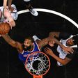Kyle O'Quinn of the New York Knicks rebounds against Trevor Booker and Justin Hamilton of the Brooklyn Nets during their game February 1, 2017