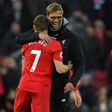 Liverpool's manager Jurgen Klopp (R) embraces midfielder James Milner at Anfield on March 12, 2017