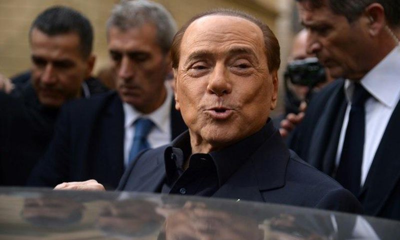Former Italian prime minister Silvio Berlusconi leaves after voting in a referendum on constitutional reforms in Rome on December 4, 2016