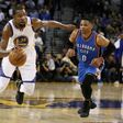 Kevin Durant (L) of the Golden State Warriors dribbles past Russell Westbrook of the Oklahoma City Thunder, at ORACLE Arena in Oakland, California, on January 18, 2017