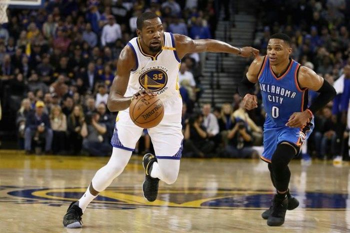 Kevin Durant (L) of the Golden State Warriors dribbles past Russell Westbrook of the Oklahoma City Thunder, at ORACLE Arena in Oakland, California, on January 18, 2017