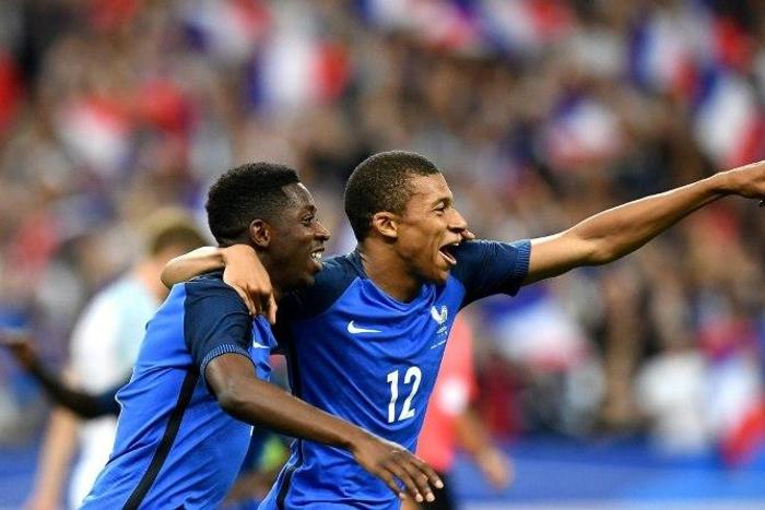 France's forward Ousmane Dembele (L) is congratulated by France's midfielder Kylian Mbappe following his goal during the international friendly football match against England at the Stade de France stadium June 13, 2017