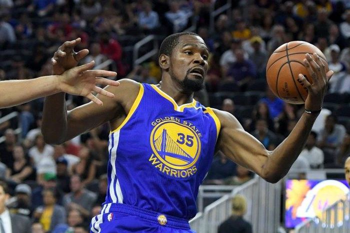 Kevin Durant of the Golden State Warriors grabs a rebound against the Los Angeles Lakers during their pre-season game at T-Mobile Arena in Las Vegas, Nevada, on October 15, 2016