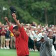 Tiger Woods raises his arms in victory after winning the 1997 Masters tournament, a turning point for the sport, the man and even the course