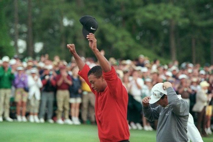 Tiger Woods raises his arms in victory after winning the 1997 Masters tournament, a turning point for the sport, the man and even the course