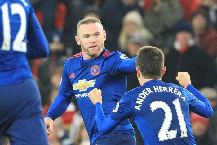 Manchester United's Wayne Rooney (C) celebrates scoring an equalising goal and his 250th goal for Manchester United making him the club's all-time record scorer during the English Premier League football match against Stoke City on January 21, 2017