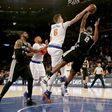 Kristaps Porzingis of the New York Knicks blocks a shot by Kawhi Leonard of the San Antonio Spurs in the fourth quarter, at Madison Square Garden in New York, on February 12, 2017