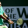 Nick Kyrgios of Australia returns a shot to Novak Djokovic of Serbia during the BNP Paribas Open at the Indian Wells Tennis Garden on March 15, 2017 in Indian Wells, California