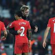 Liverpool manager Jurgen Klopp (2R) hugs hisdefender Nathaniel Clyne (2L) after the English Premier League match against Stoke City at Anfield in Liverpool, north-west England on December 27, 2016