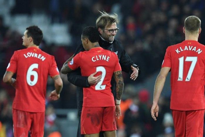 Liverpool manager Jurgen Klopp (2R) hugs hisdefender Nathaniel Clyne (2L) after the English Premier League match against Stoke City at Anfield in Liverpool, north-west England on December 27, 2016