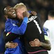 Leicester City's Wilfred Ndidi (L) and goalkeeper Kasper Schmeichel celebrate victory at the end of their UEFA Champions League round of 16 2nd leg match against Sevilla, at the King Power Stadium in Leicester, on March 14, 2017