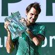 Roger Federer of Switzerland lifts the trophy following his victory over compatriot Stan Wawrinka in the ATP Indian Wells Masters final match, in California, on March 19, 2017