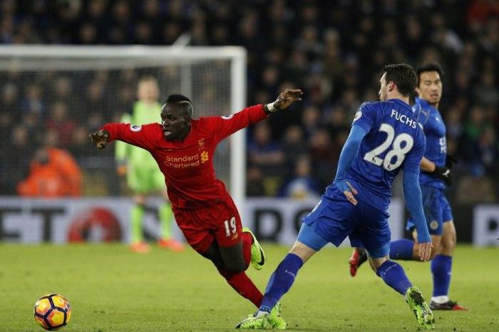 Leicester City defender Christian Fuchs (R) tackles Liverpool forward Sadio Mane during the English Premier League match at King Power Stadium in Leicester, central England on February 27, 2017
