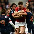 Wales' wing George North (C) is tackled during a Six Nations match against Wales at the Stade de France in Saint-Denis, outside Paris, on March 18, 2017