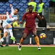 Makeshift Napoli forward Dries Mertens (C) shoots as Roma defenders Kostas Manolas (L) and Antonio Rudiger look on during Italian Serie A match at the Olympic Stadium in Rome on March 4, 2017