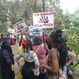 Kenyans prostitutes hold placards in protest over the murder of their colleague.
