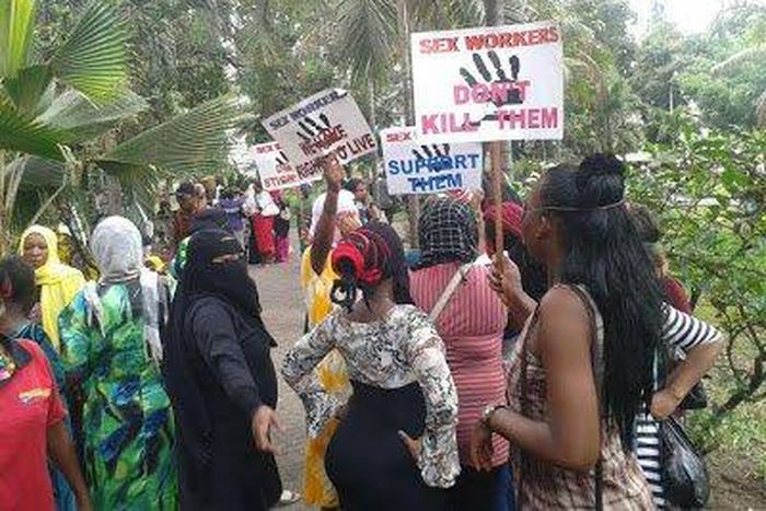Kenyans prostitutes hold placards in protest over the murder of their colleague.