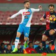 Napoli's Dries Mertens (L) fights for the ball with Genoa's Santiago Gentiletti during their match on February 10, 2017, at the San Paolo Stadium in Naples