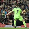 Liverpool's midfielder James Milner (R) shoots from the penalty spot to score his team's first goal past Manchester United's goalkeeper David de Gea (C) during the English Premier League football match on January 15, 2017