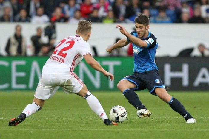 Hoffenheim's forward Sandro Wagner and Hamburg's defender Matthias Ostrzolek (L) fight for the ball during the Bundesliga football match in Sinsheim on November 20, 2016