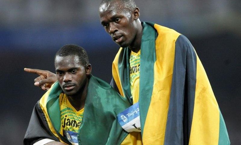 Jamaica's Nesta Carter (L), who tested positive for a banned substance, and Usain Bolt (R) were teammates in the men's 4×100m relay final during the 2008 Beijing Olympic Games, where they won gold