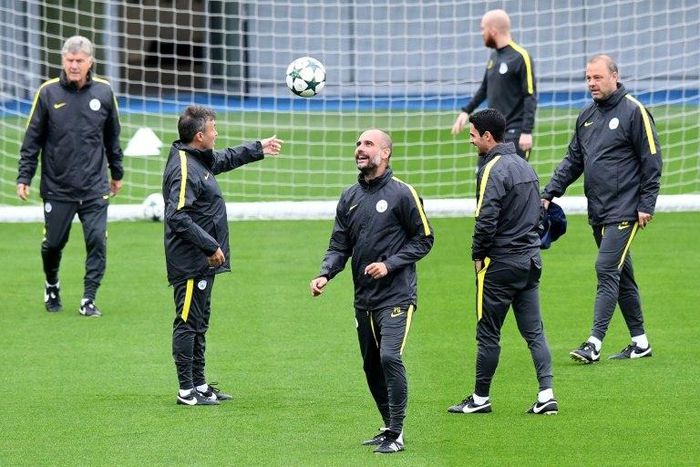 Manchester City's manager Pep Guardiola (C) controls the ball during a team training session at Manchester City Football Academy Campus in Manchester, on September 27, 2016