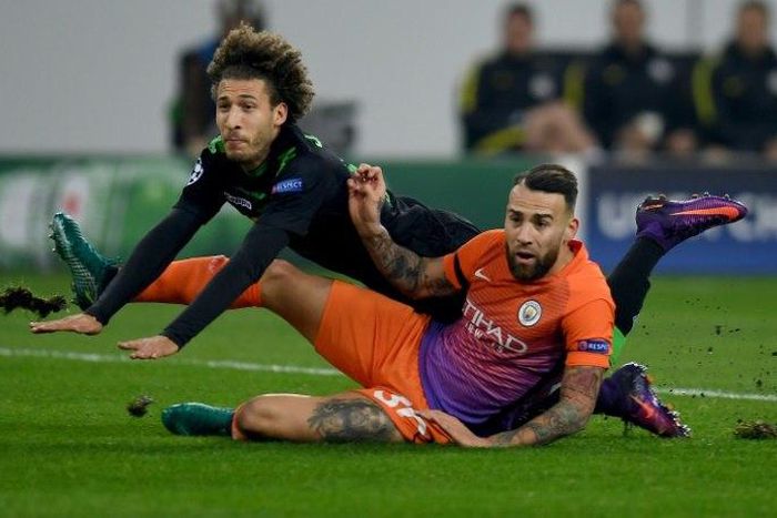 Moenchengladbach's defender Fabian Johnson and Manchester City's defender Nicolas Otamendi fight for the ball