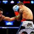 Jesus Cuellar (L) of Argentina punches Jonathan Oquendo of Puerto Rico during their WBA Featherweight Championship bout on December 5, 2015 in New York City