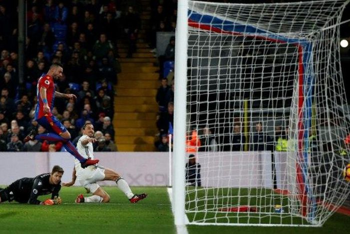 Manchester United's striker Zlatan Ibrahimovic (R) slides the ball into the goal to score their second goal during the English Premier League football match between Crystal Palace and Manchester United on December 14, 2016