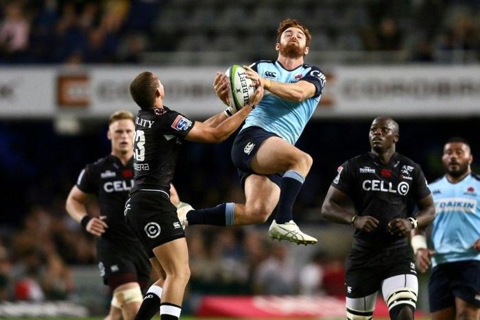 Sharks' Curwin Bosch (L) and Waratahs' Andrew Kellaway go for the ball during their Super Rugby match, at Kings Park rugby stadium in Durban, South Africa, on March 11, 2017