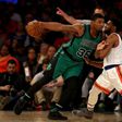 Marcus Smart (L) of the Boston Celtics drives as Chasson Randle of the New York Knicks defends on April 2, 2017