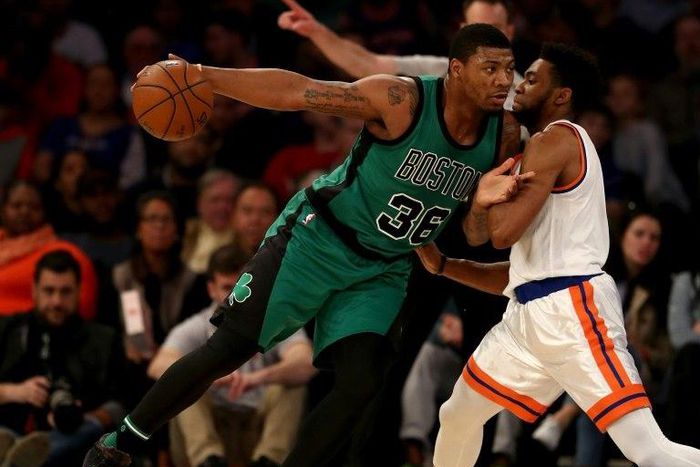 Marcus Smart (L) of the Boston Celtics drives as Chasson Randle of the New York Knicks defends on April 2, 2017