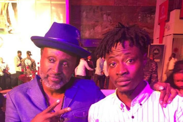 Fancy Gadam shows off his award with Reggie Rockstone