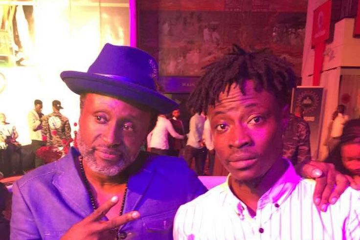 Fancy Gadam shows off his award with Reggie Rockstone