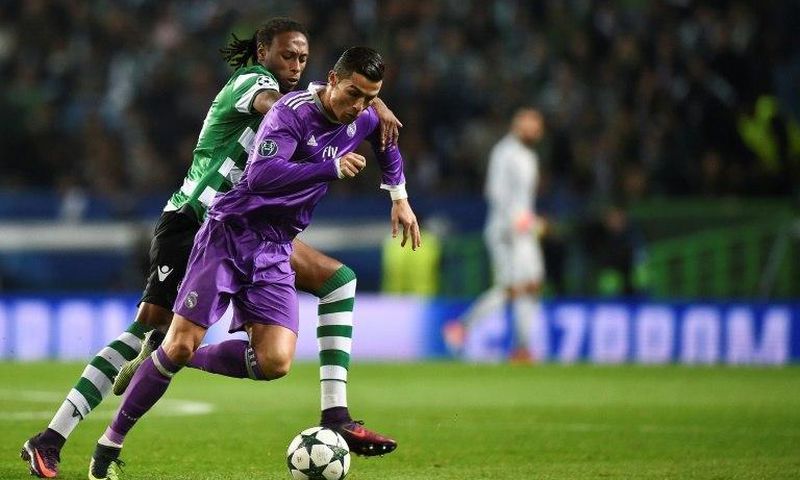 Real Madrid's forward Cristiano Ronaldo (R) clashes with Sporting's defender Ruben Semedo on November 22, 2016