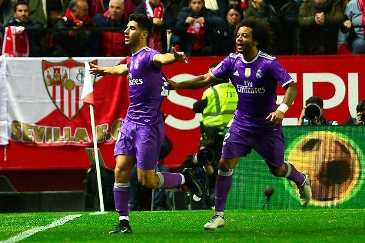 Real Madrid's midfielder Marco Asensio (L) celebrates with Real Madrid's Brazilian defender Marcelo after scoring against Sevilla during a Spanish Copa del Rey round of 16 match on January 12, 2017