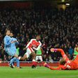 Arsenal's Alex Iwobi (3L) shoots and scores past Stoke City's goalkeeper Lee Grant at the Emirates Stadium in London