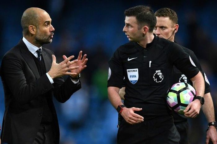 Manchester City's manager Pep Guardiola (L) speaks with referee Michael Oliver after the English Premier League football match between Manchester City and Liverpool on March 19, 2017