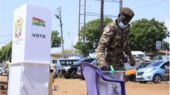 A security officer casting his ballot